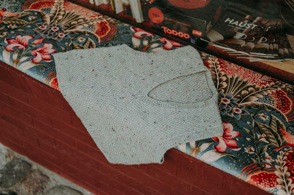 Knitted item on a floral-patterned surface