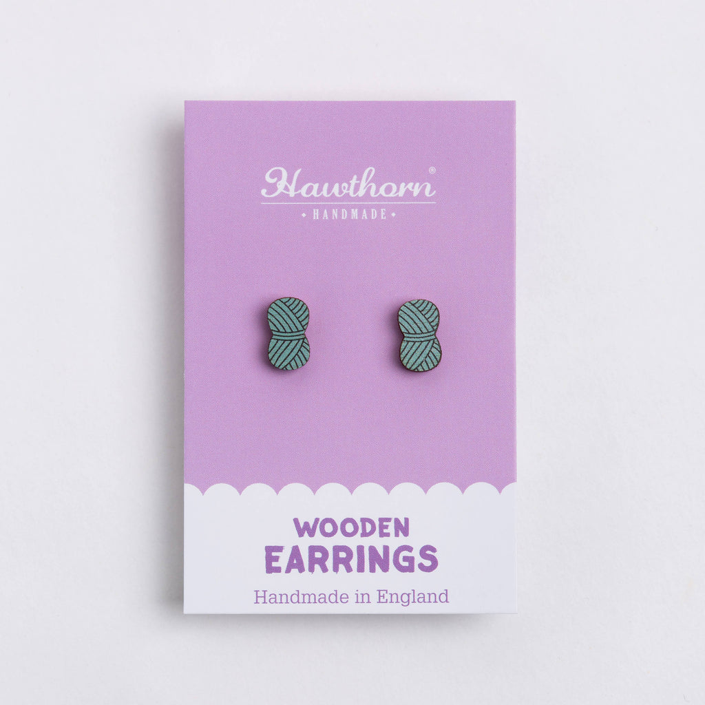 Wooden earrings on a purple card with 'Hawthorn' branding
