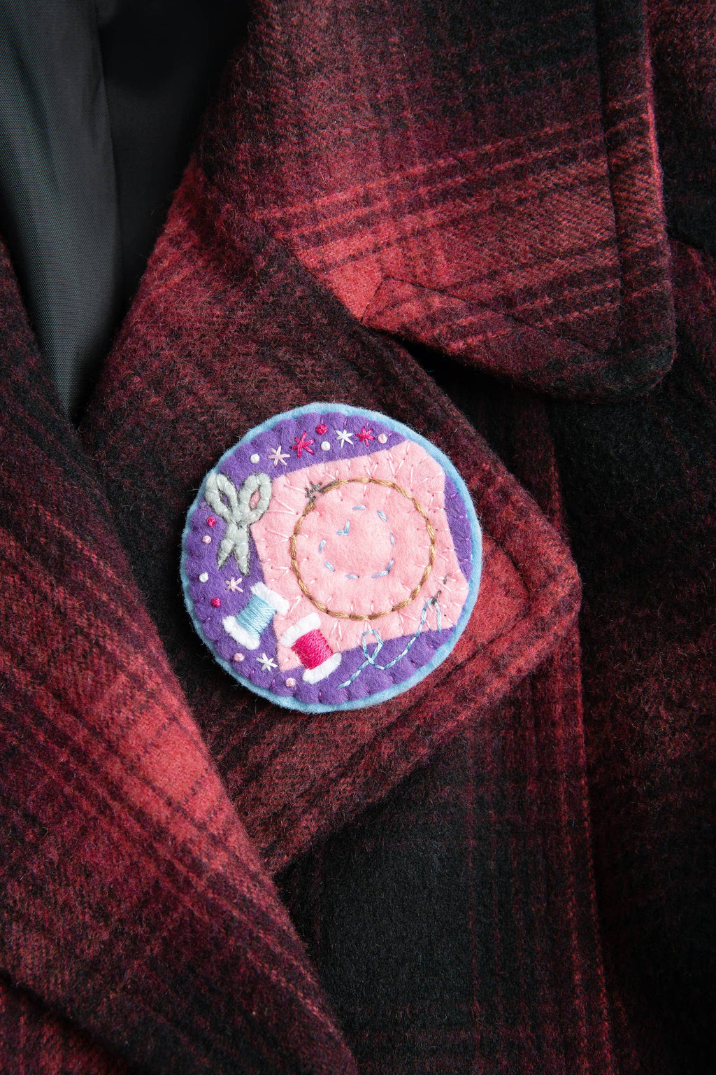 Decorative patch on a red plaid coat